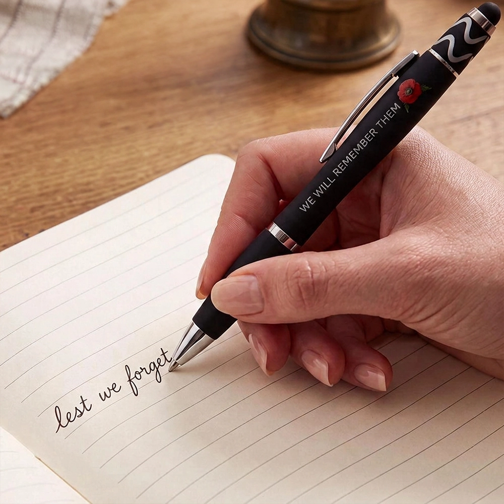 A woman writing in a notebook using the Forever Remember Stylus Pen