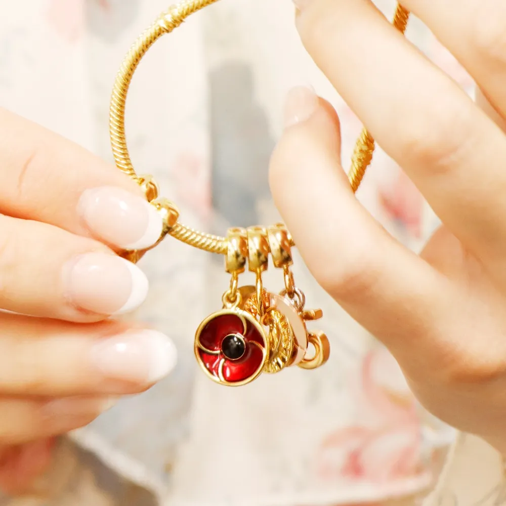 Close up of Gold Remember bracelet with gold charms