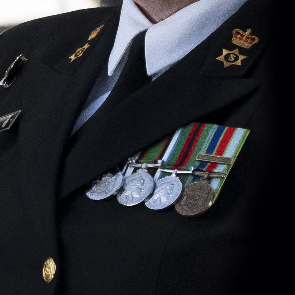 A New Zealand Navy memeber wearing medals.